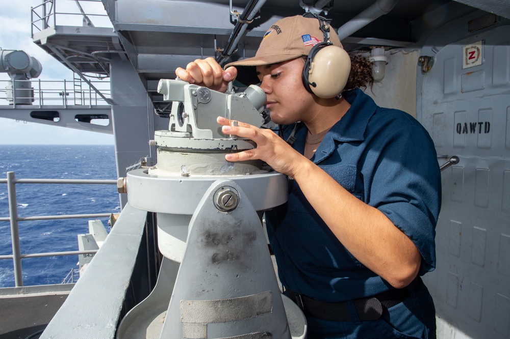USS Carl Vinson (CVN 70) Quartermaster uses a magnetic compass
