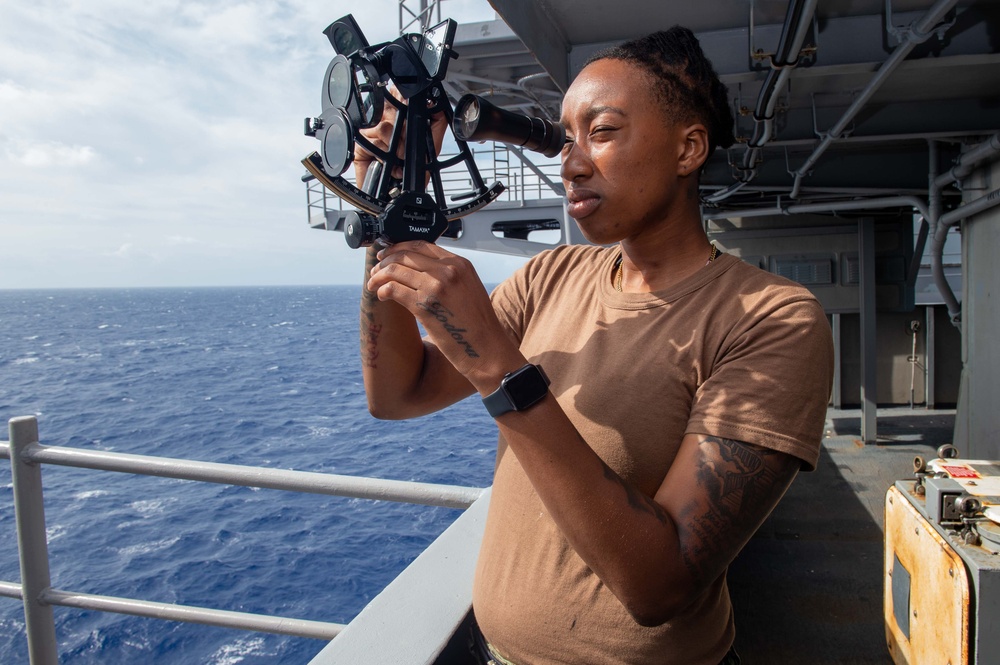 USS Carl Vinson (CVN 70) Quartermaster uses a sextant