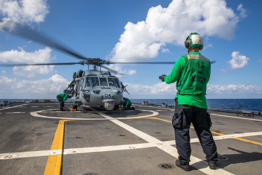 HSC 22 Sailor Signals to Pilots in an MH-60S Sea Hawk Helicopter
