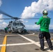 HSC 22 Sailor Signals to Pilots in an MH-60S Sea Hawk Helicopter