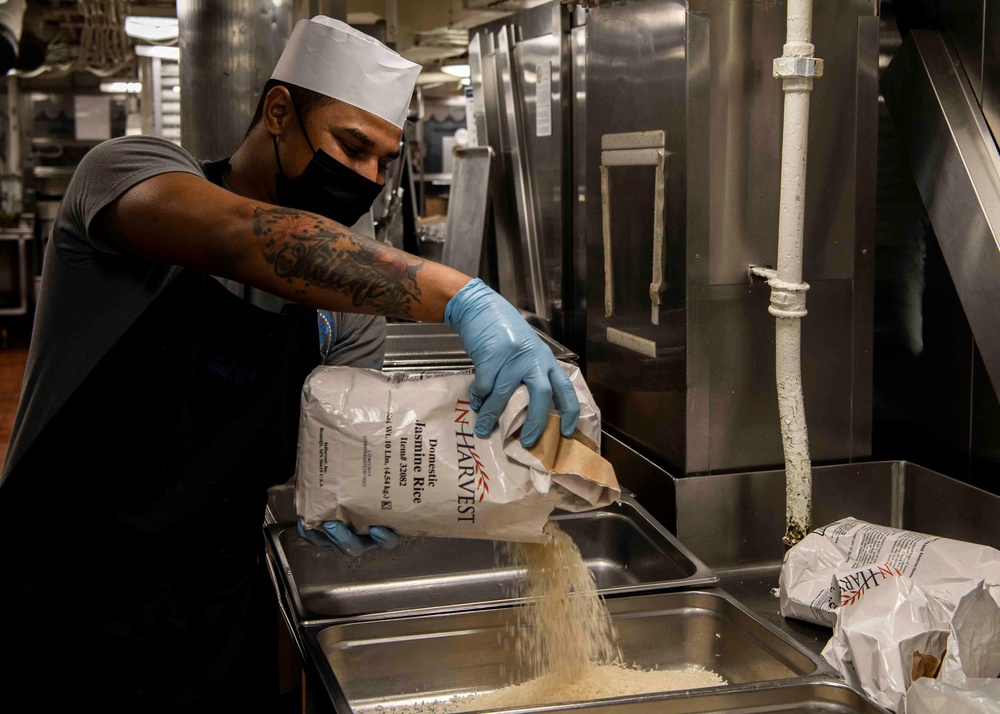 Abraham Lincoln Sailors serve food