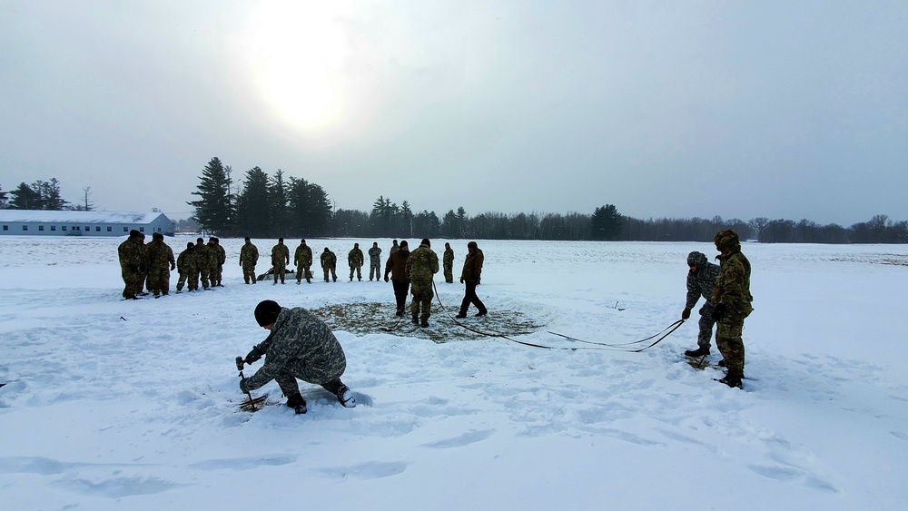 Cold-Weather Operations Course class 22-02 students learn about Arctic tent on snowy training day