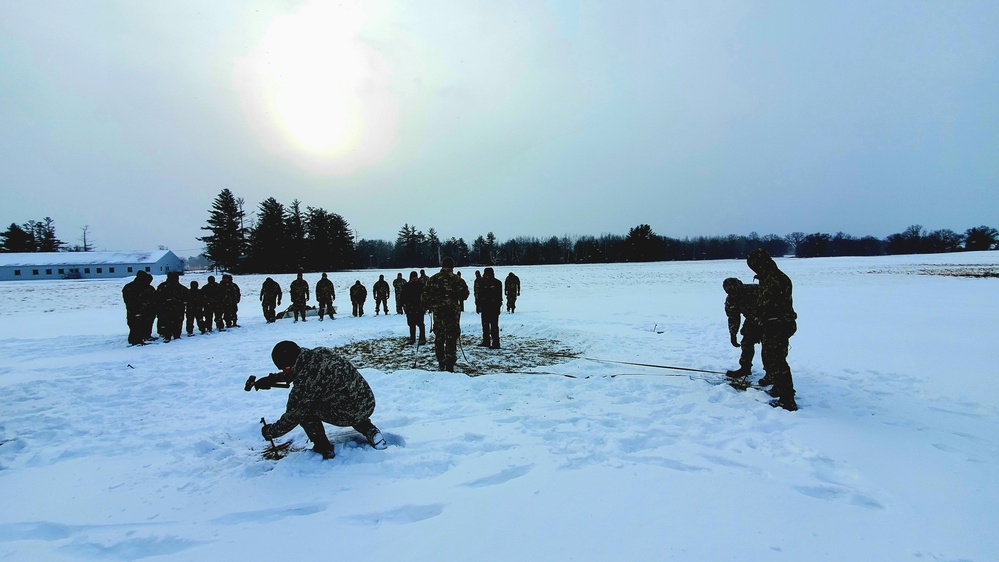 Cold-Weather Operations Course class 22-02 students learn about Arctic tent on snowy training day