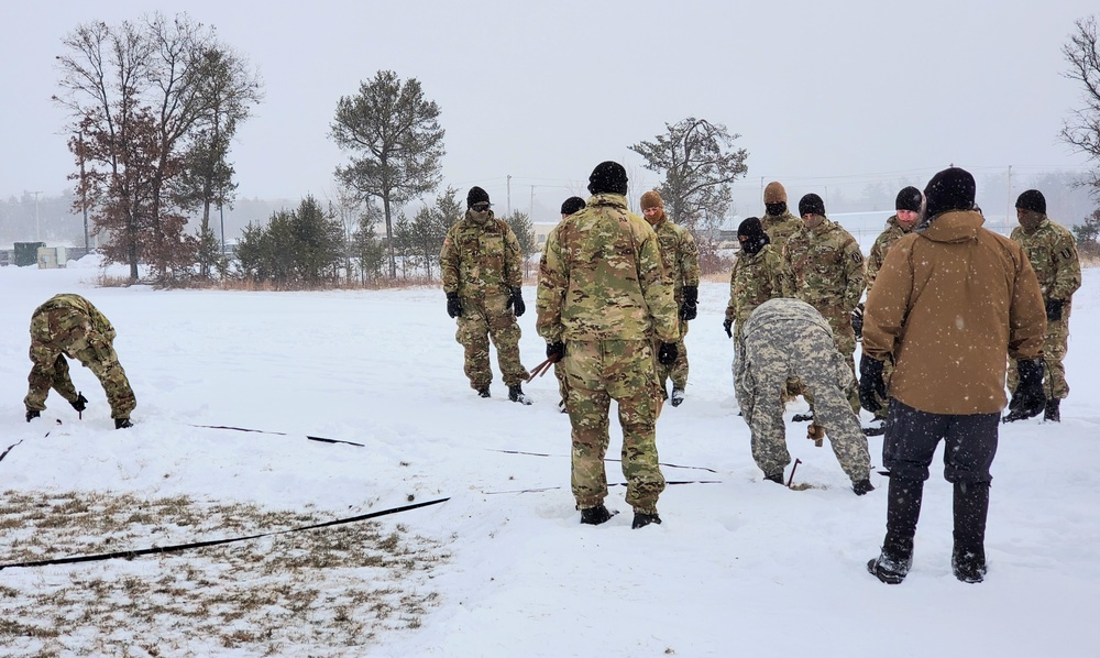 Cold-Weather Operations Course class 22-02 students learn about Arctic tent on snowy training day