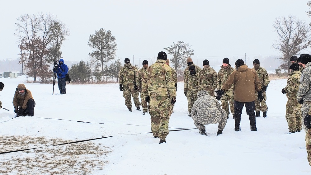 Cold-Weather Operations Course class 22-02 students learn about Arctic tent on snowy training day