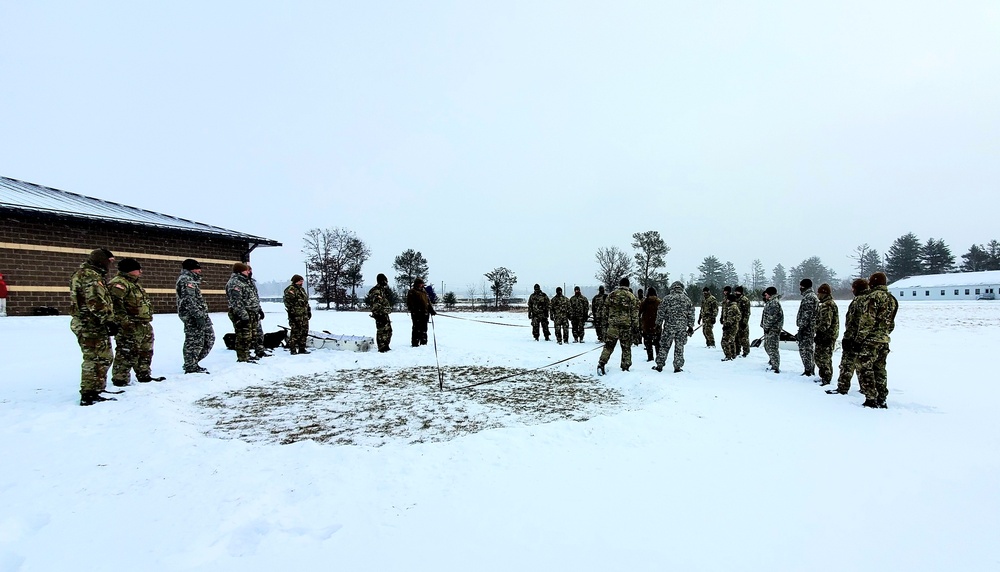 Cold-Weather Operations Course class 22-02 students learn about Arctic tent on snowy training day