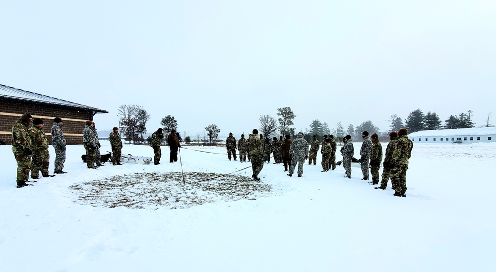 Cold-Weather Operations Course class 22-02 students learn about Arctic tent on snowy training day