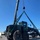 US Navy Seabees with NMCB-5 load a grader for equipment disposition onboard Camp Shields
