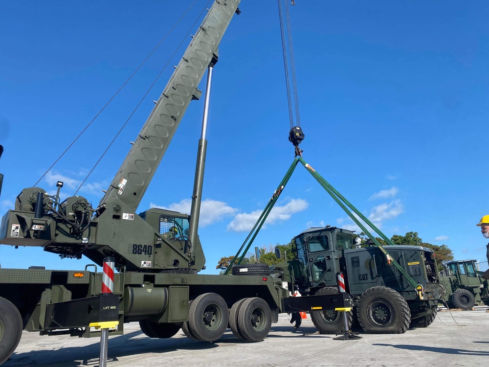 US Navy Seabees with NMCB-5 load a grader for equipment disposition onboard Camp Shields