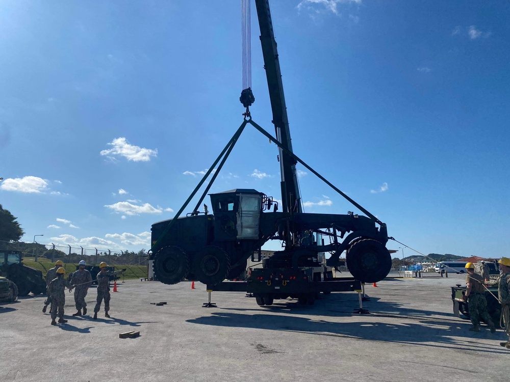 US Navy Seabees with NMCB-5 load a grader for equipment disposition onboard Camp Shields