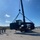 US Navy Seabees with NMCB-5 load a grader for equipment disposition onboard Camp Shields