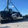 US Navy Seabees with NMCB-5 load a grader for equipment disposition onboard Camp Shields