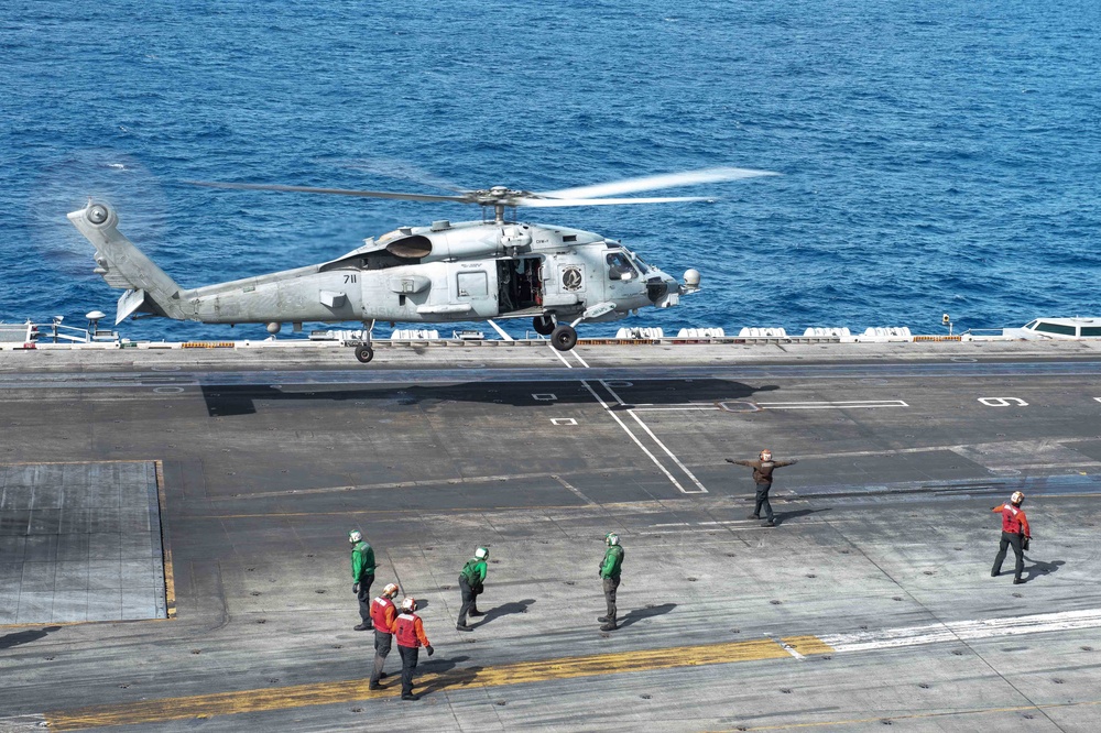 Helicopter takes off from the USS Carl Vinson (CVN 70) flight deck