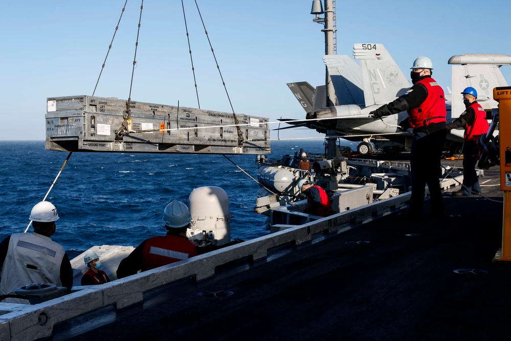 Abraham Lincoln Sailors move and load ordnance.