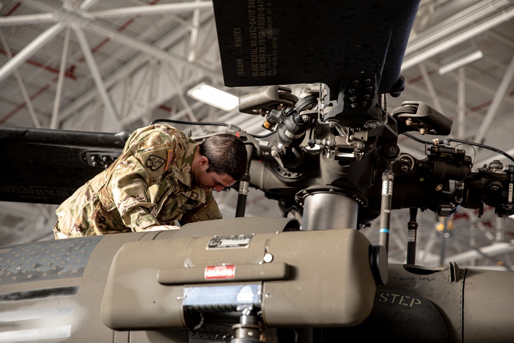 U.S. Army Chief Warrant Officer 2 Brandon Delgado performing pre-flight inspection on HH-60 Black Hawk