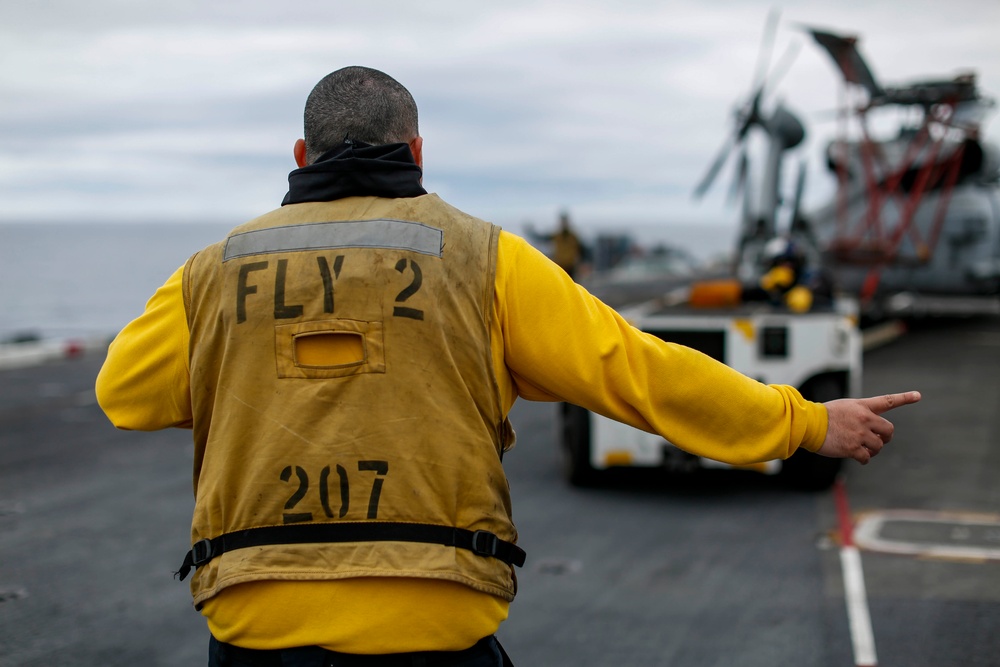 Abraham Lincoln Sailors move aircraft.