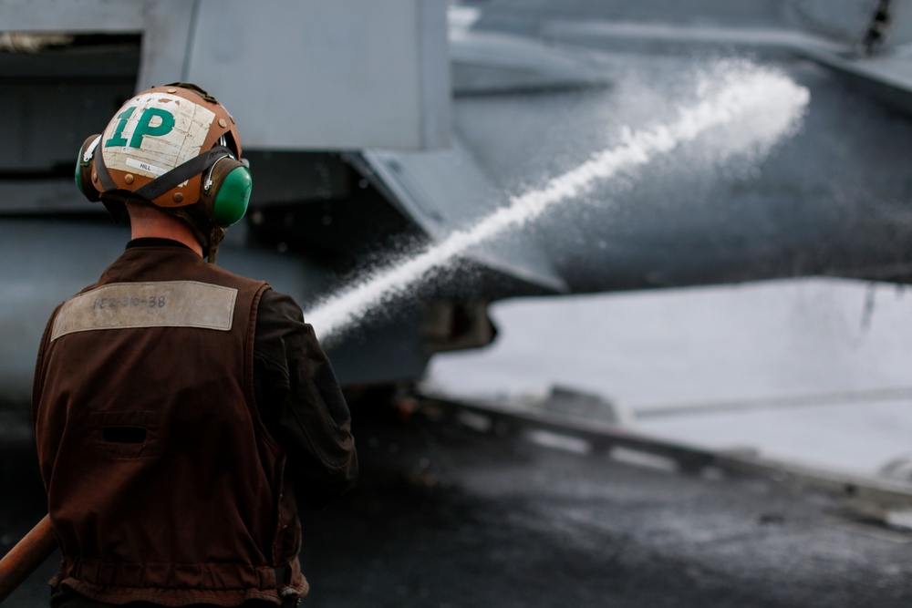 Abraham Lincoln Sailors perform maintenance.