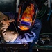USS Carl Vinson (CVN 70) Sailor Welds in Machine Shop