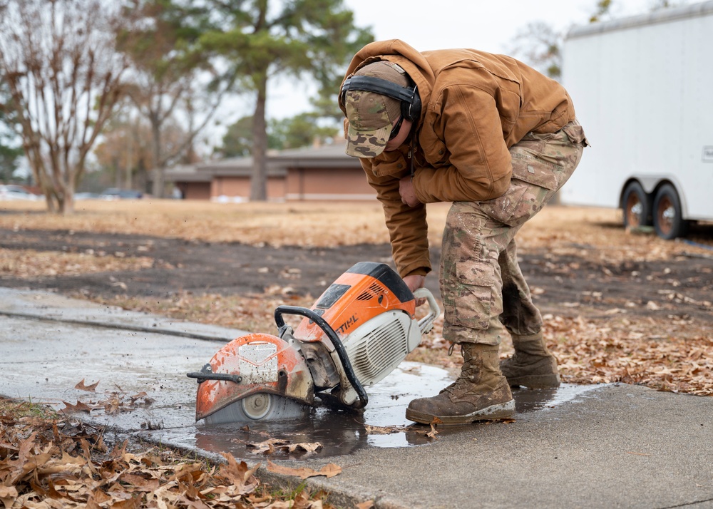 Maintenance and pavement technician construct sidewalk