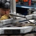 F-16 aircraft metals technician grinds out corrosive deposits on aluminum equipment