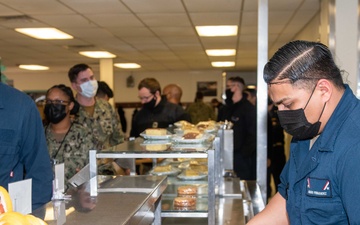 Sailor serves food in the galley