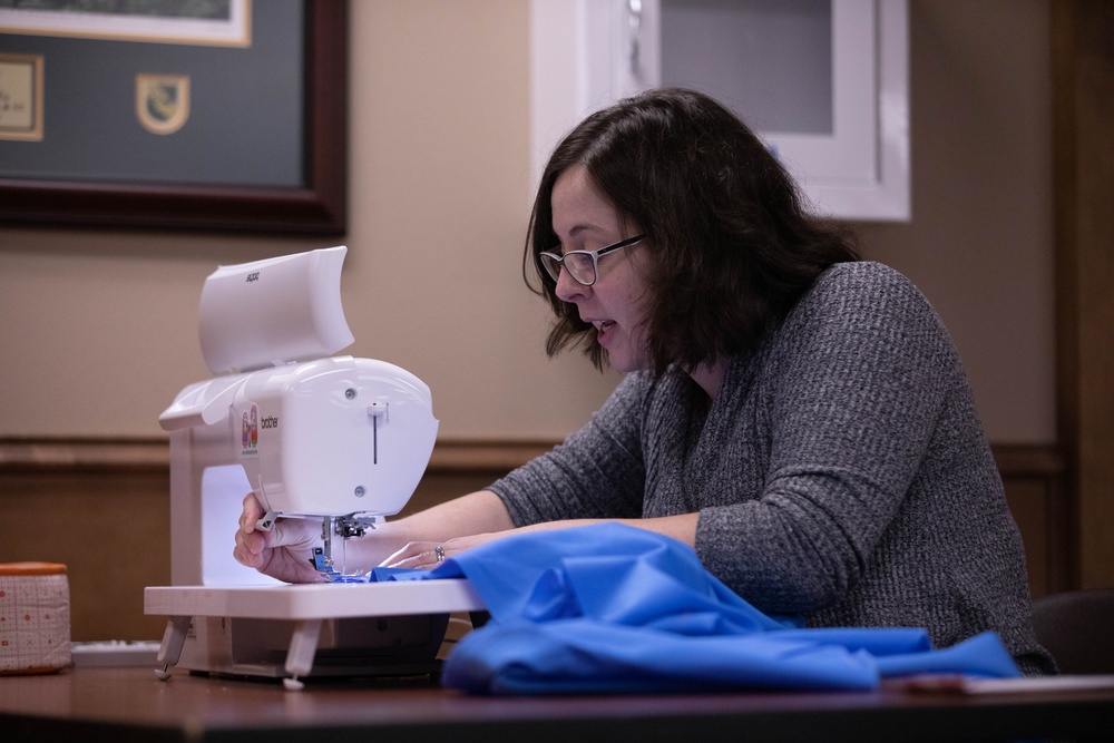 1st SFG (A) spouses with F.I.R.S.T. Mentorship Program craft quilts for displaced Afghan families