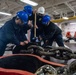 Sailors aboard the forward-deployed amphibious assault ship USS America (LHA 6) conduct an anchor drop test in the ships fo’c’sle.