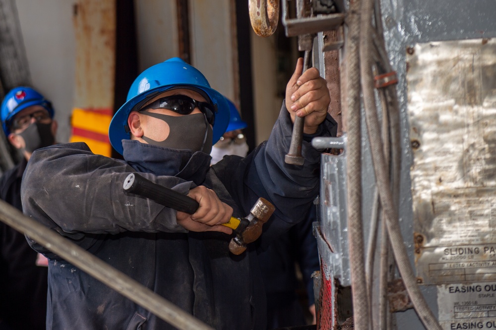 USS Ronald Reagan (CVN 76) Sailors Perform Maintenance On The Hangar Bay