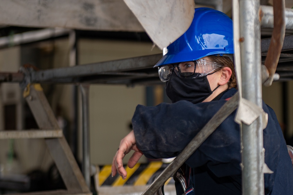 USS Ronald Reagan (CVN 76) Sailors Perform Maintenance On The Hangar Bay