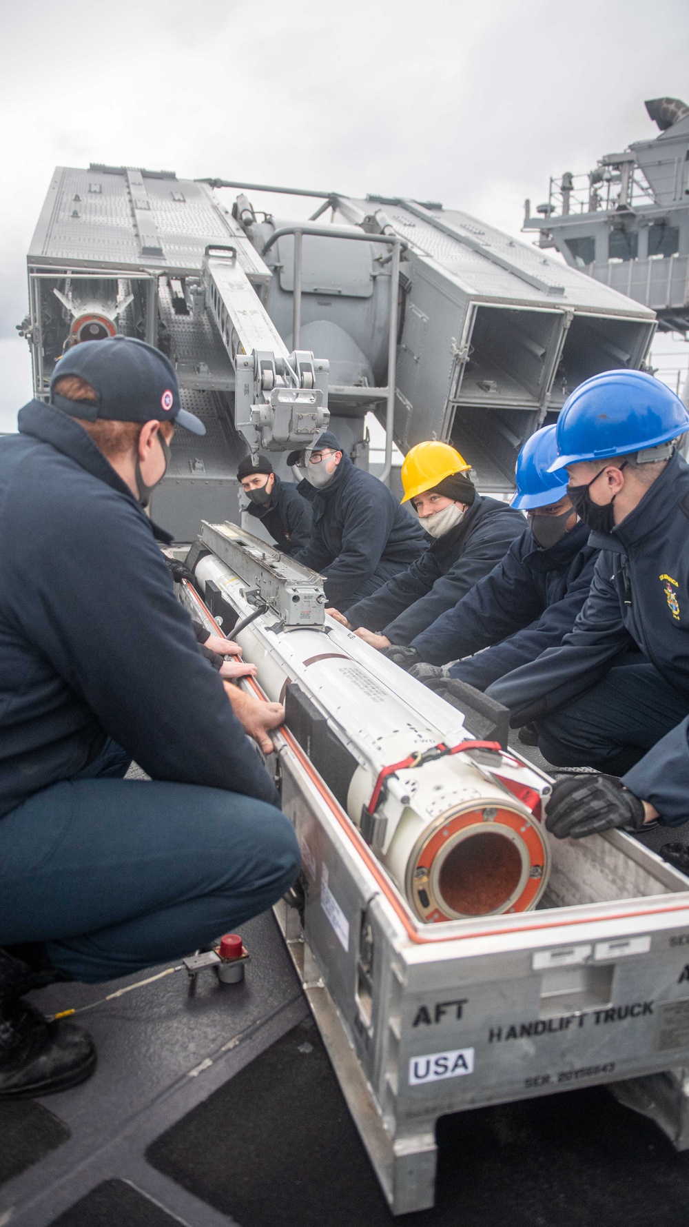 USS America (LHA 6) sailors,  load up Evolved Sea Sparrow missiles.