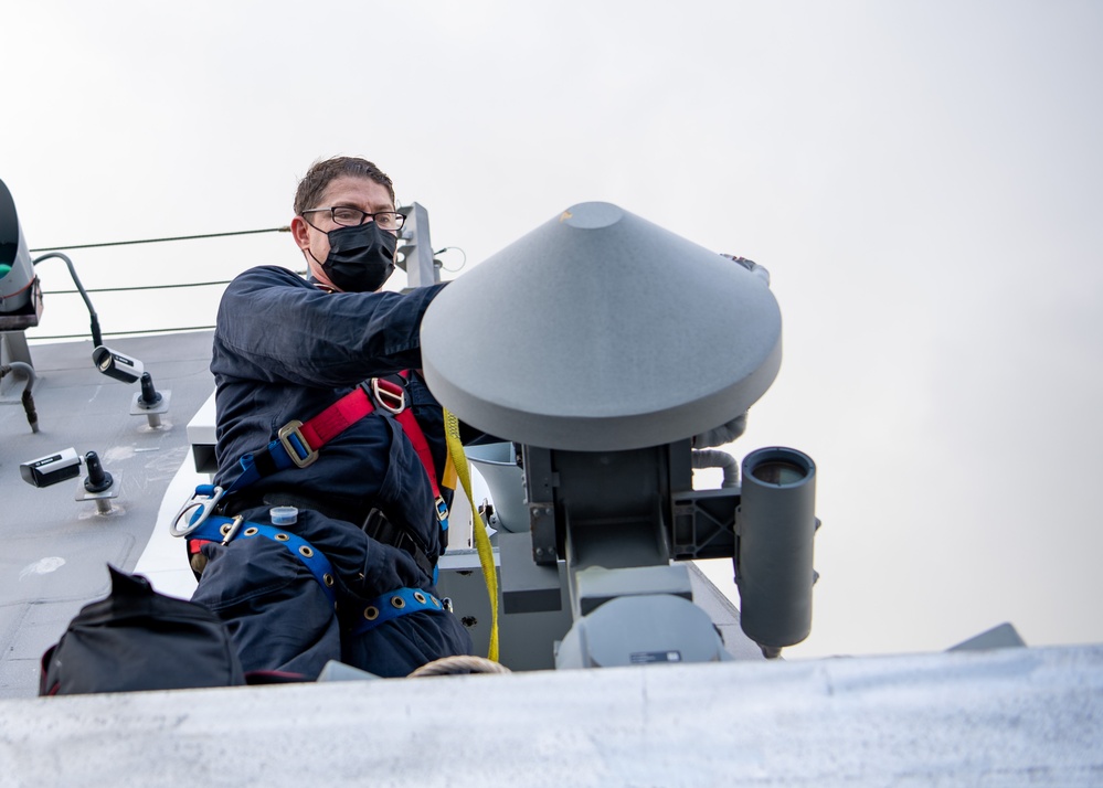 Sailor aboard USS Charleston conducts maintenance on UAV Automatic Recovery System