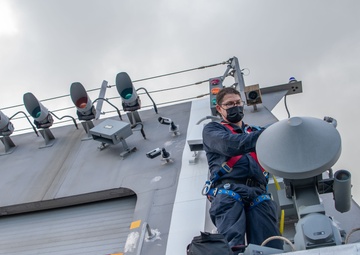 Sailor aboard USS Charleston conducts maintenance on UAV Automatic Recovery System