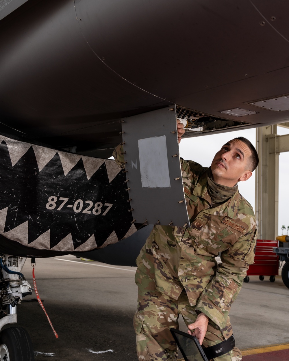 Inspects circuit breaker on F-16