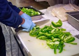 USS Charleston Culinary Specialist Prepares Bell Peppers