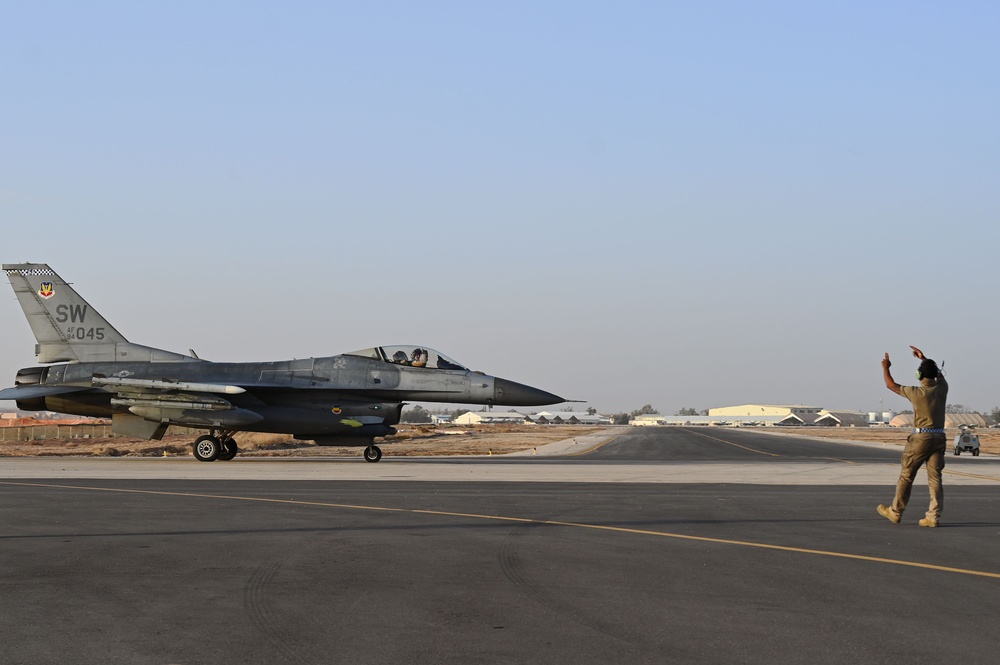 332ND AEW maintenance Airmen, aircraft at sunset