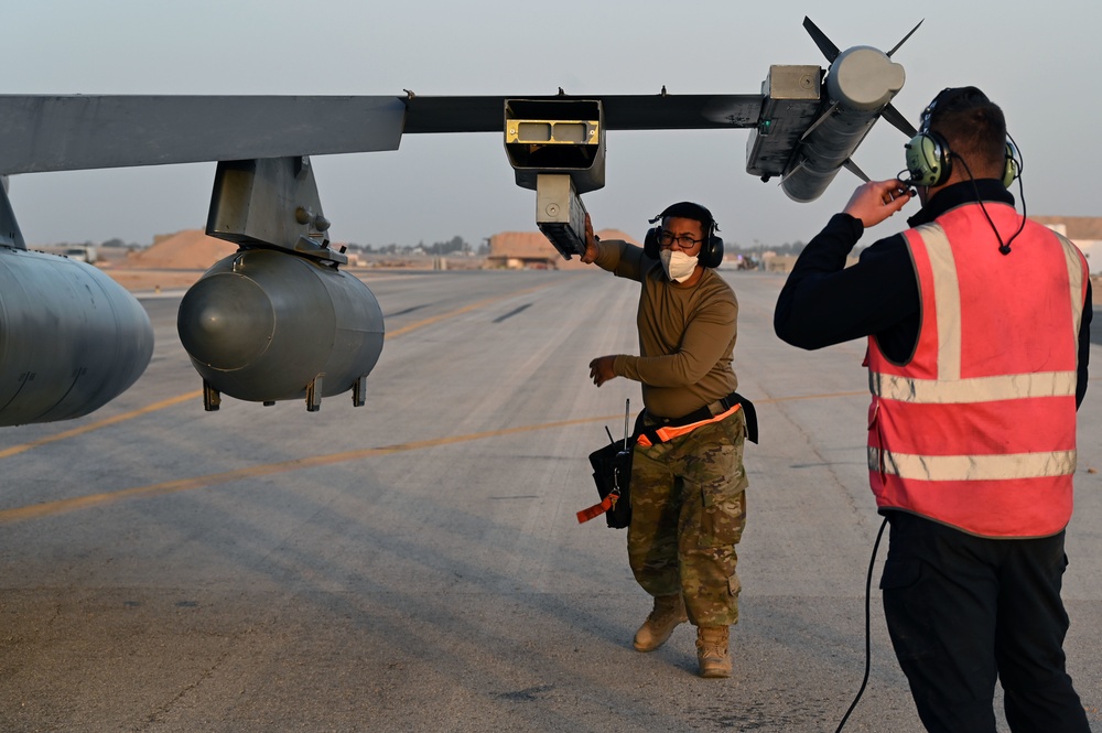 332ND AEW maintenance Airmen, aircraft at sunset