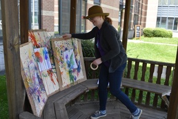 Library technician arranges ax-throwing art at gazebo