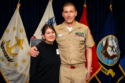 Father administers oath of enlistment to daughter