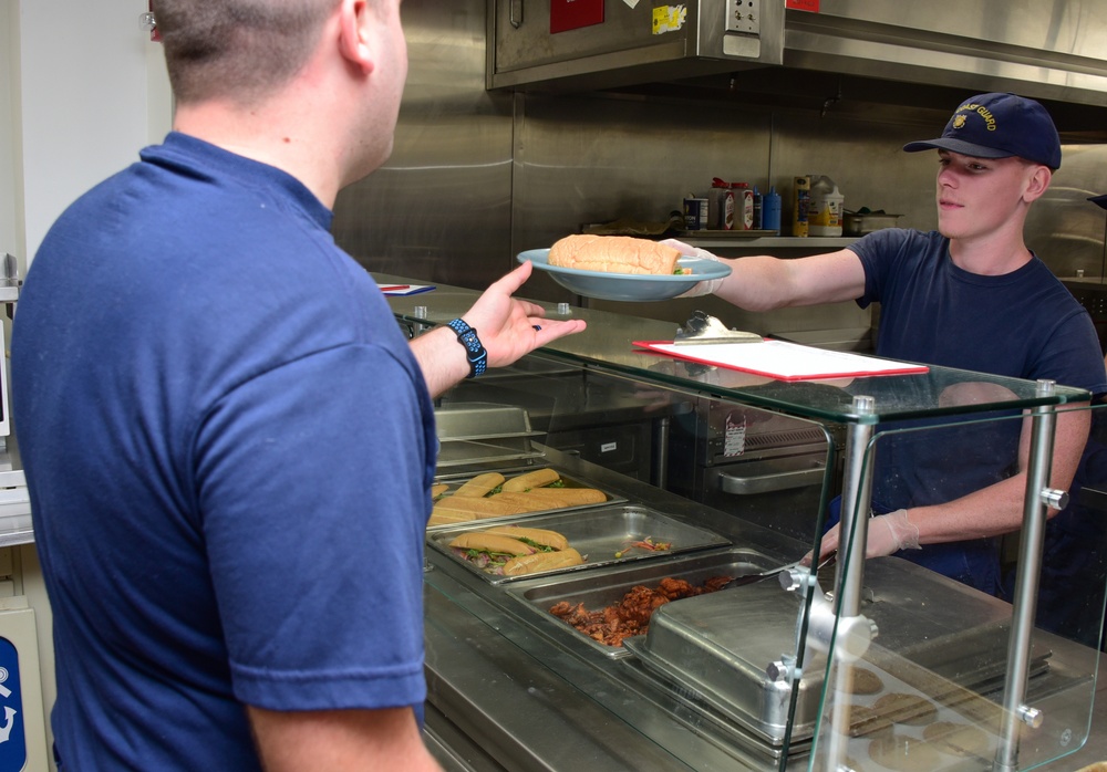 Photo of Coast Guardsman Serving Lunch