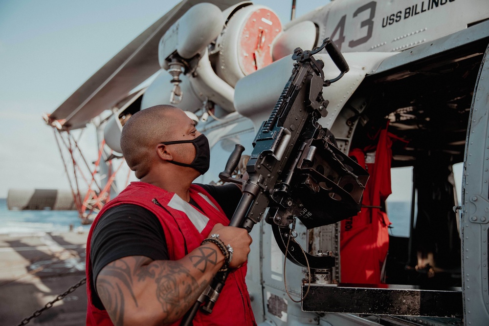 HSC 28 Sailor Preps Machine Gun on Helo