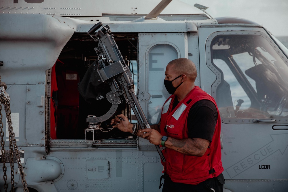 HSC 28 Sailor Preps Machine Gun on Helo