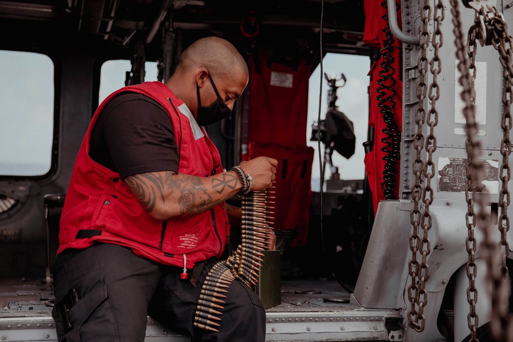 HSC 28 Sailor Preps Machine Gun on Helo