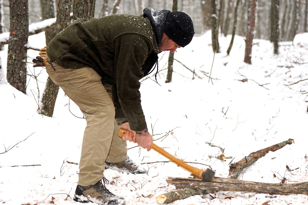 Instructor Chops Wood for Cold Weather Survival Training during Northern Strike 22