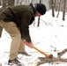 Instructor Chops Wood for Cold Weather Survival Training during Northern Strike 22