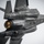 A close-up aerial photograph of a U.S. military stealth fighter jet, identifiable as an F-35 Lightning II, viewed from below and slightly behind. The aircraft is captured in flight against an overcast gray sky, with its single engine exhaust nozzle glowing orange-gold, indicating active thrust. The image showcases the aircraft's distinctive angular stealth geometry, panel lines, and dark gray low-observable coating.