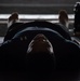 Sailors participate in a yoga class in the hangar bay of USS Carl Vinson