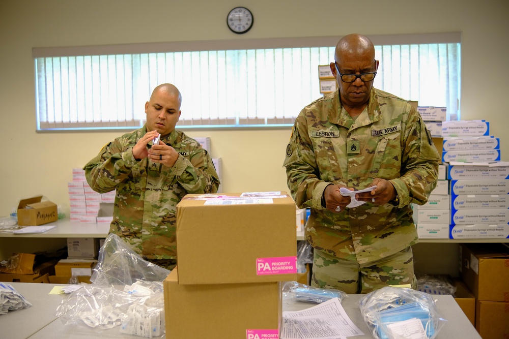 Soldiers prepare COVID-19 boxes for distribution
