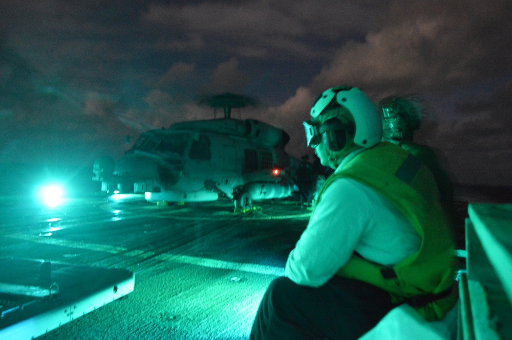 USS Lake Champlain conducts night flight operations in the Philippine Sea