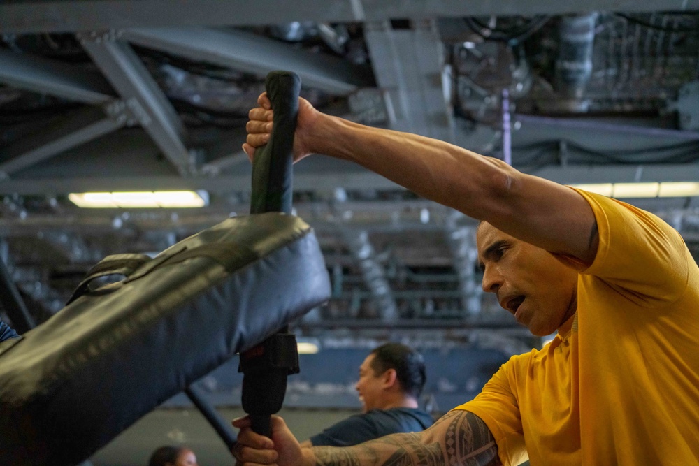 USS Jackson (LCS 6) Sailor Conducts Non Lethal Weapons Training