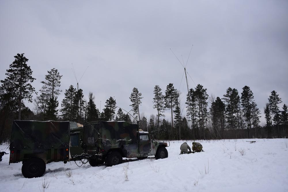 Soldiers set up an antenna to support artillery communication